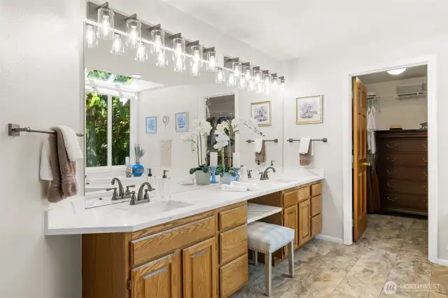 Dual sink vanity with expansive quartz counter space. New light fixtures, faucets, and hardware.