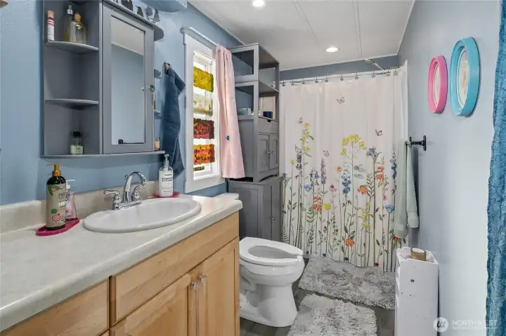 New bathroom update with paint, LVP flooring, custom built-ins and walk in shower!!!