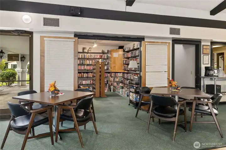 Library room showing part of the dining area and kitchen.