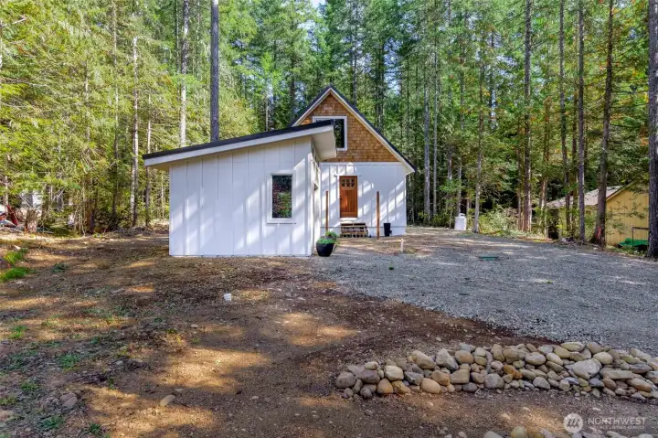 Cedar Shingles stained to preserve natural color with painted Cement Siding - Board /Batt, Vinyl Windows and Sliding glass door for your future deck.  Propane Hot Water Tank.