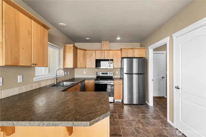 Kitchen with bar eating and new appliances