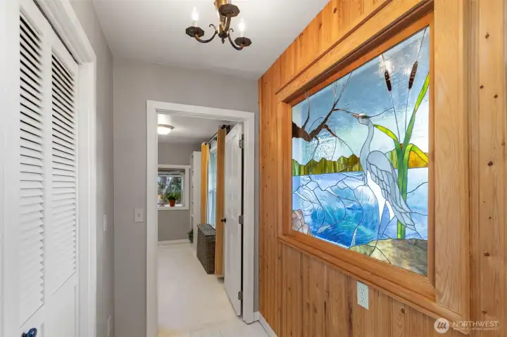 Stained glass, eclectic lighting, coffered ceilings, and knotty pine walls are sure to enchant.