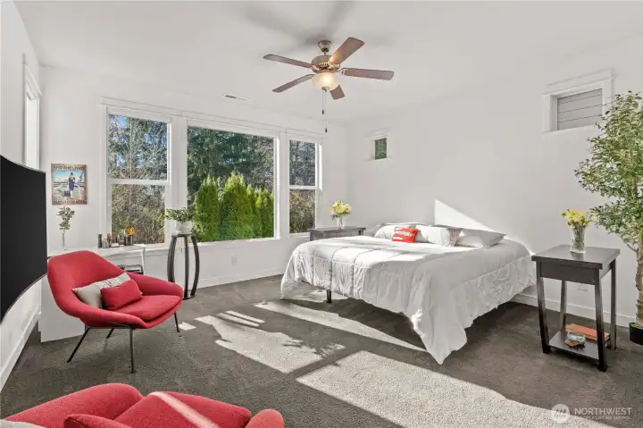 Primary suite is filled with light and at the back of the home for privacy and the best views of the greenspace behind the home