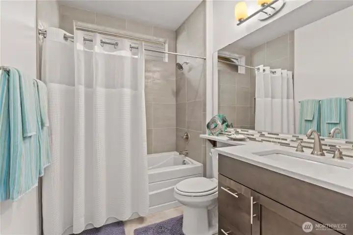 Secondary bathroom is equally matched in elegance and that neutral color palate