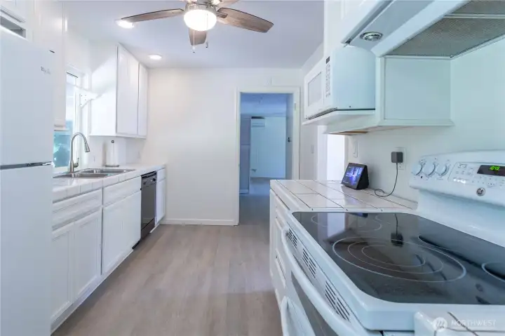 Ceiling fan in kitchen and wood floors