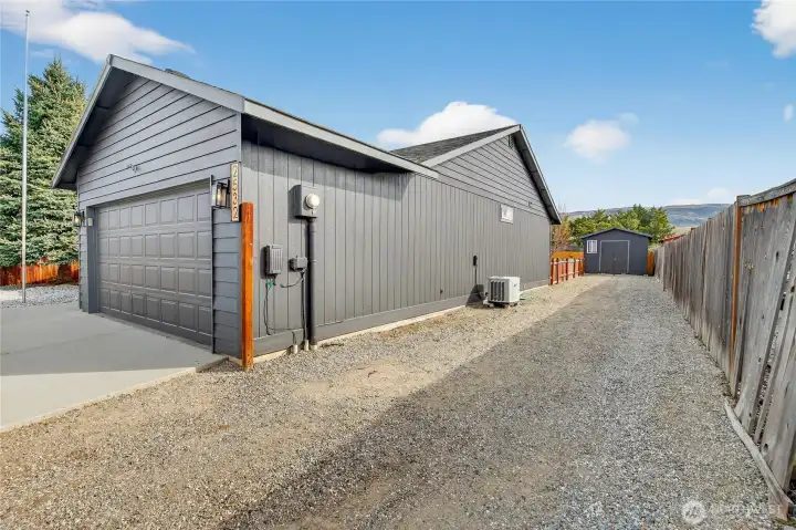 Graveled RV parking running the length of the house