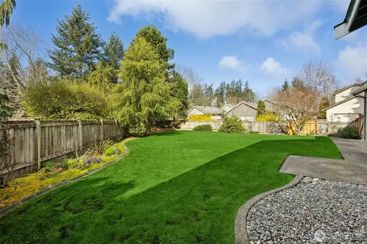 Rare, extra large, fully fenced backyard with mature landscaping.
