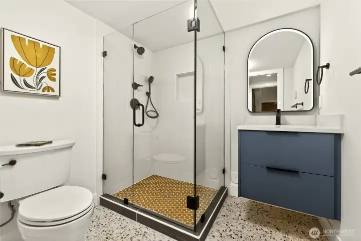 True retro inspired bathroom with heated terrazzo floors and back-lit LED mirror.