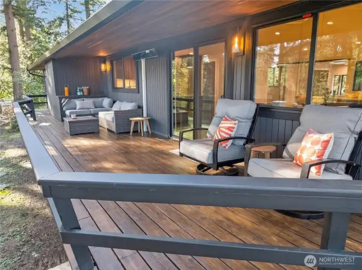 Amazing covered deck spans the entire length of the house and features a Smart Bromic Patio Heater and bonus storage.