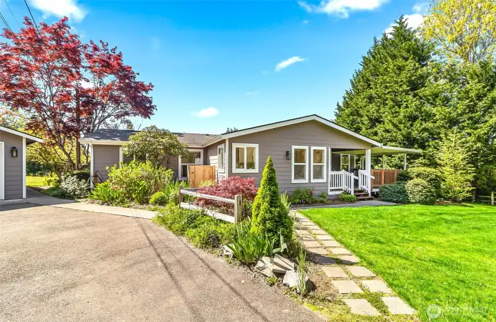 Paved driveway and walkways between the home and garage