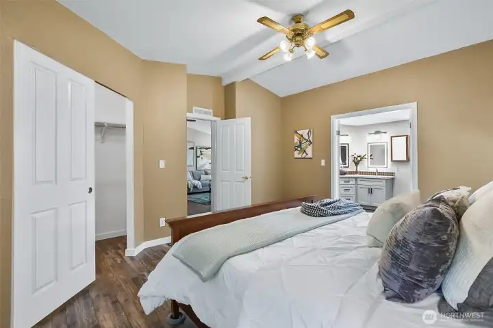 Primary bedroom showing walk-in closet at left, entry at center and 3/4 bathroom at right.
