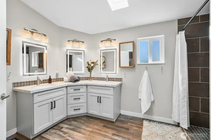 All the bells and whistles here!  Fully tiled shower, self-lighting mirrors along with Quartz surfaces.