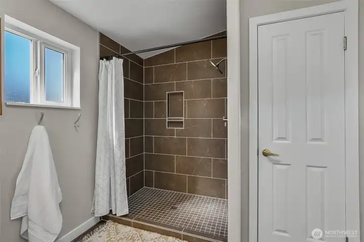 Primary bathroom shower and linen closet