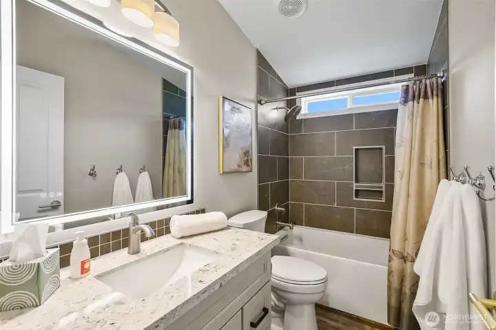 Hallway guest bathroom, again with high-end finishes.