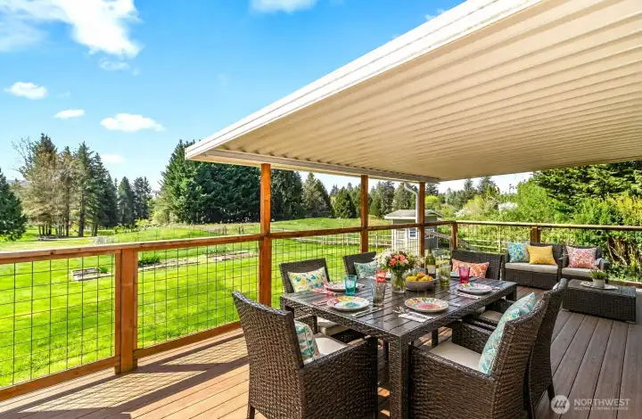 Back deck overlooks the acreage and is partly covered.  (Virtually staged)