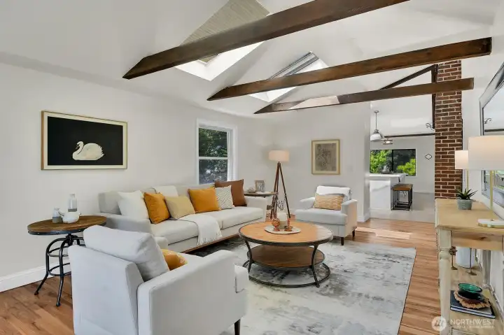 Spacious open living area with dramatic wood beams, cozy atmosphere, and bright natural light throughout. Spacious open living area with dramatic wood beams, cozy atmosphere, and bright natural light throughout.
