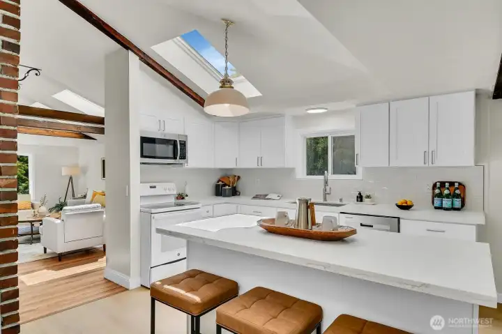 Beautifully updated kitchen with skylights, large island seating, and open-concept flow into the main living space. Beautifully updated kitchen with skylights, large island seating, and open-concept flow into the main living space.