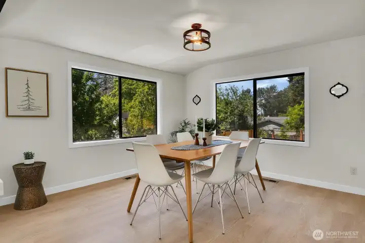 Sun-filled dining area with large picture windows and inviting space for gatherings, entertaining, and everyday meals. Sun-filled dining area with large picture windows and inviting space for gatherings, entertaining, and everyday meals.