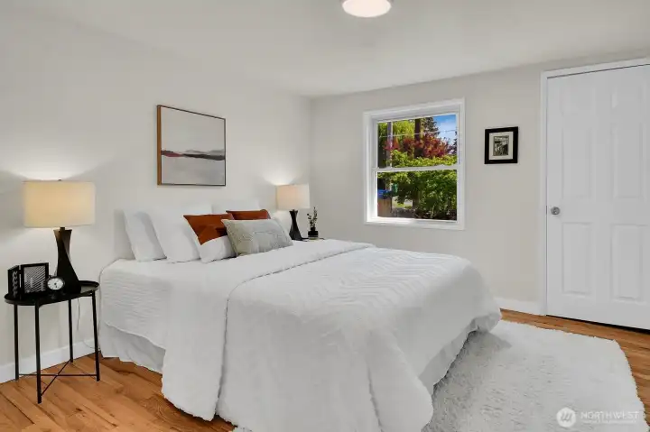 Main-floor bedroom with hardwood floors, natural light, and peaceful layout designed for comfort and relaxation. Main-floor bedroom with hardwood floors, natural light, and peaceful layout designed for comfort and relaxation.