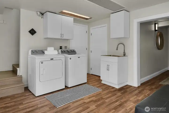 Bright and functional laundry room with utility sink, extra storage space, and updated finishes for everyday convenience. Extra 3rd toliet Bright and functional laundry room with utility sink, extra storage space, and updated finishes for everyday convenience. Extra 3rd toliet
