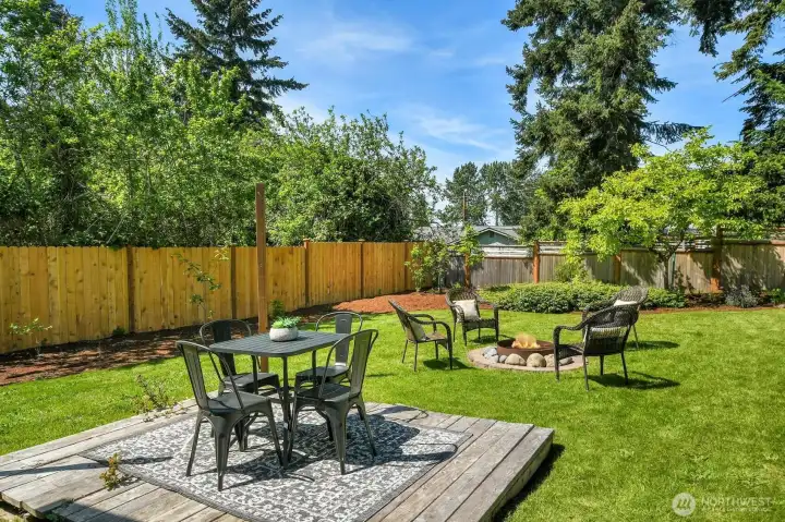 Backyard patio and fire pit area perfect for summer entertaining, outdoor dining, and relaxing evenings at home. Backyard patio and fire pit area perfect for summer entertaining, outdoor dining, and relaxing evenings at home.
