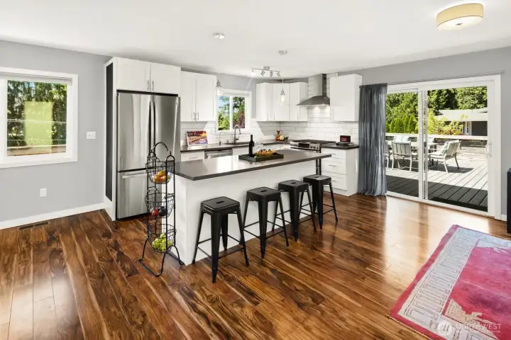 As you enter the home to the right, you see the Updated kitchen with quartz countertops and stainless steel appliances.