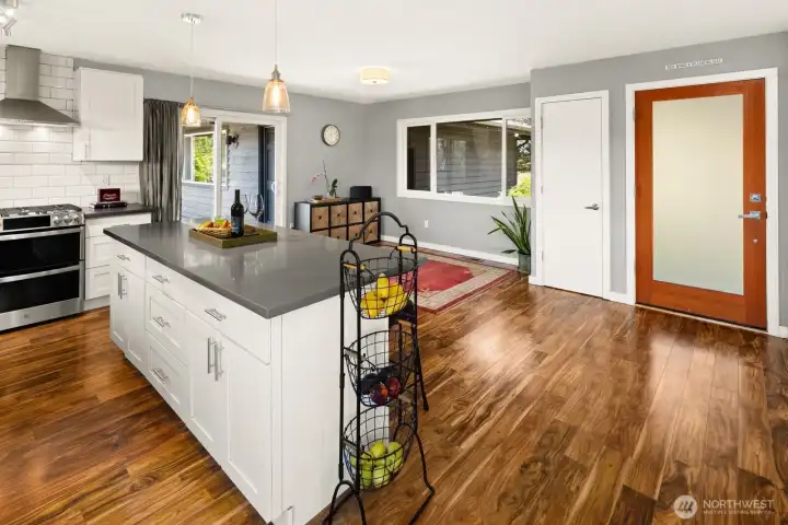 The kitchen looks out on the front entrance, coat closet and seating area.
