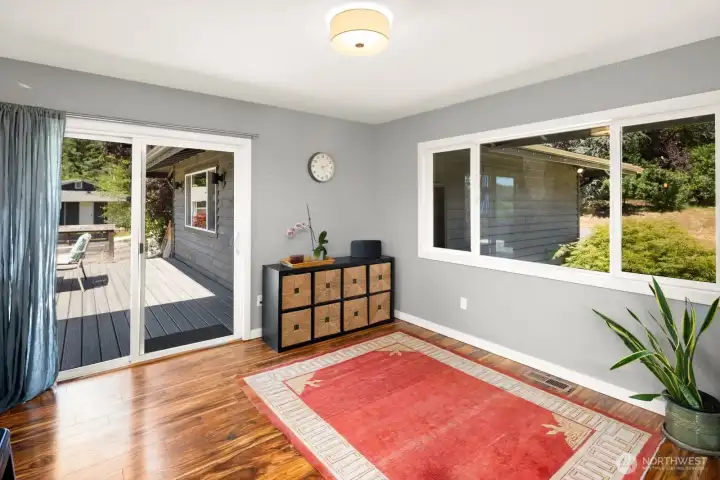To the right of the front door is another space for eating, play or crafts.  Enjoy the window looking out to the front entry.  Run out through the glass door to the garage via the deck entrance.