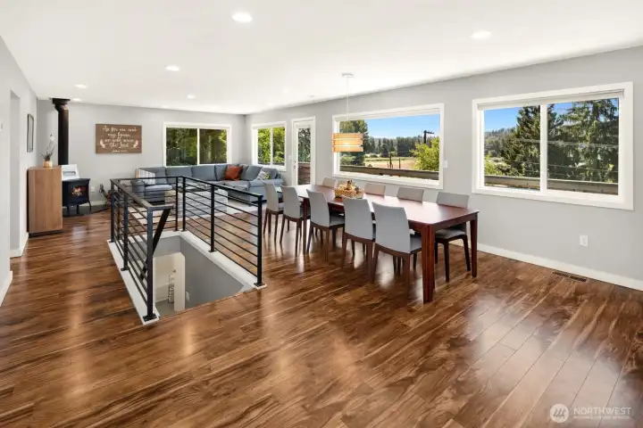 As you enter the home, to the left you see the bucolic views out the window and to the left you see the living room and dining space.