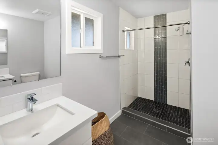 Attached Primary Bedroom Suite Bathroom features a step-in shower and two sinks.