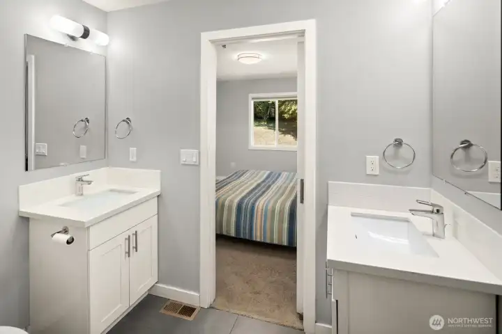 Attached Primary Bedroom Suite Bathroom features a step-in shower and two sinks.