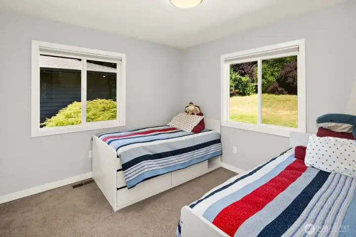 Bedroom #3 Overlooks the water feature on the front porch and the sunny east-facing window highlighting the front yard will help you get up in the morning!