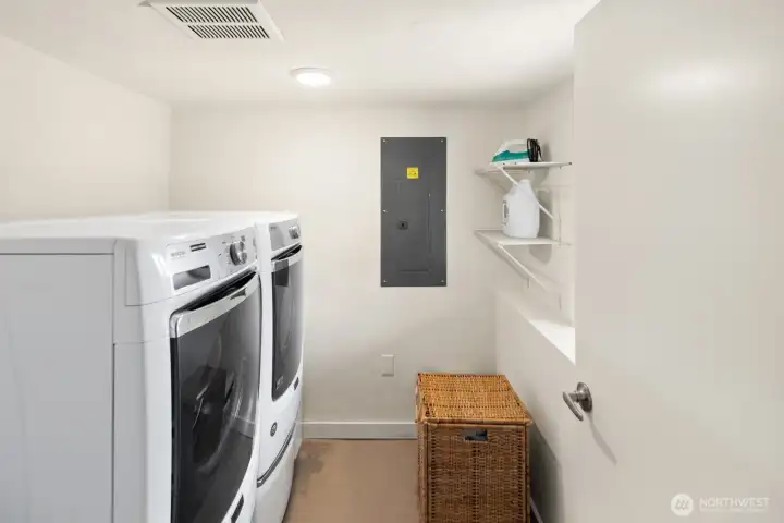 Clean and functional laundry room offers additional storage options.