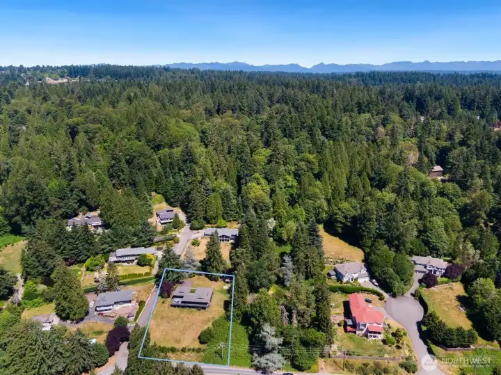 To the East, the home is backed by wooded land and the Cascade Mountains.