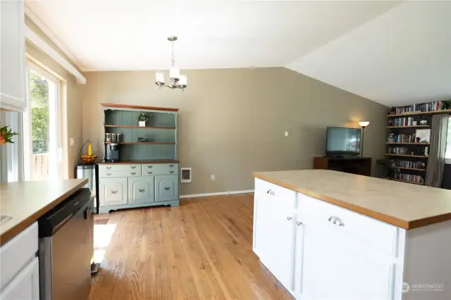 Kitchen island and dining room with sliding door to yard
