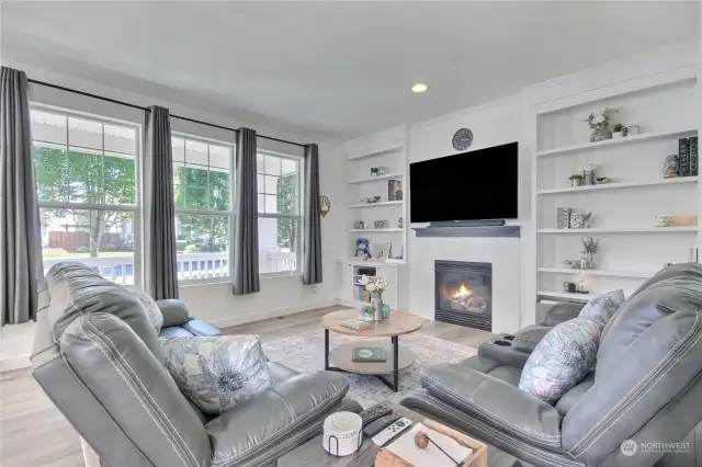 Spacious living room with built-in bookcases on each side of the gas fireplace. TV, mounting bracket, sound bar & surge protector stay with home. Seller had smurf tube installed so no wires!