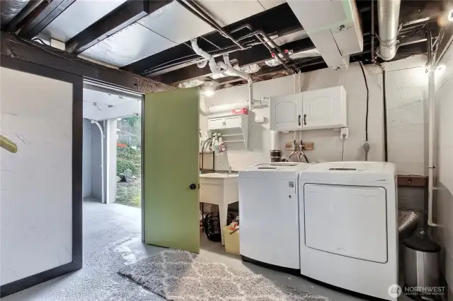 Lower level utility room, at bottom of stairs, door to garage at left.