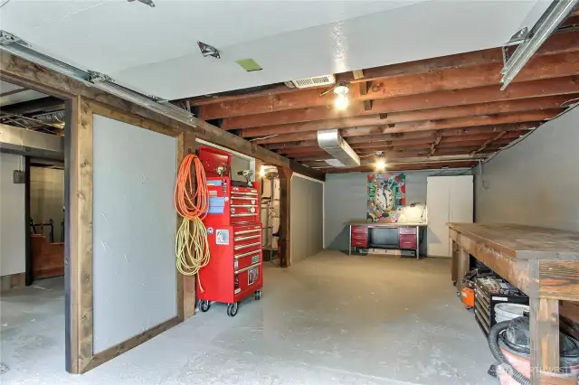 View of your extra deep garage, utility, rec room and full bath to your left, mechanical room upper left.