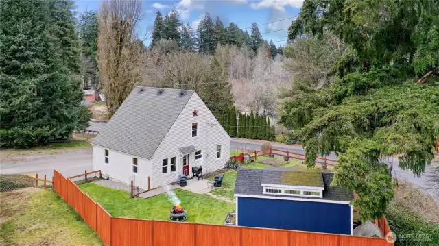 Drone view of rear of property, love the fully-fenced yard and fire pit.