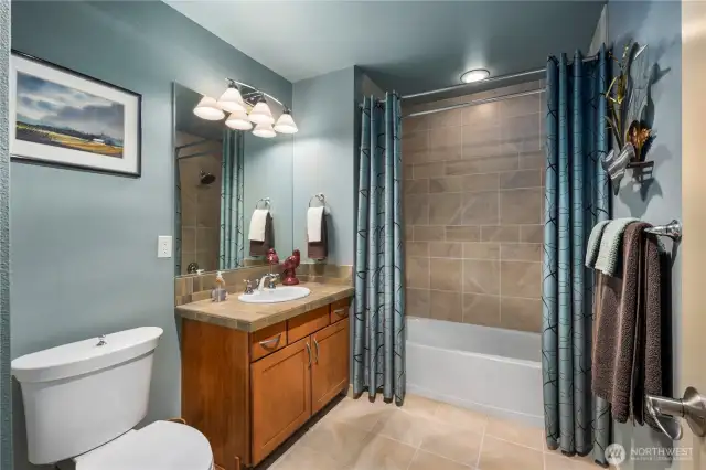 Generously sized second bathroom offers classic tub/shower combo, providing plentiful space for comfort and functionality. Modern fixtures and a well designed layout make this bathroom a practical and inviting space for everyday use.