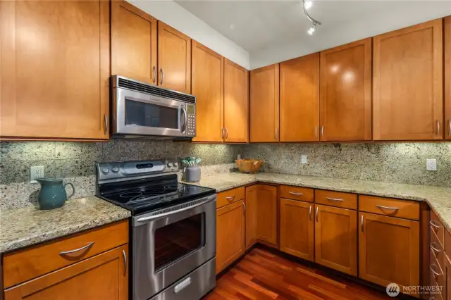Contemporary kitchen equipped with stainless steel appliances, sleek cabinetry, and abundant counter space for culinary enthusiasts.