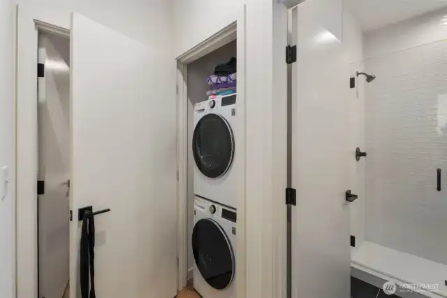 Stackable washer and dryer off primary bedroom.