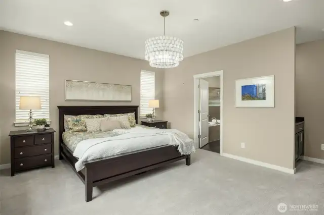 Doorway off of primary leads to luxurious bath and closet