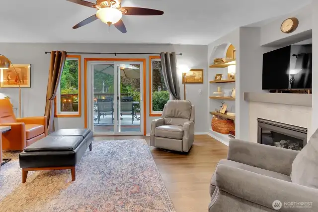Living Area with Built In Shelving & Gas Fireplace, Leads to Outside Deck