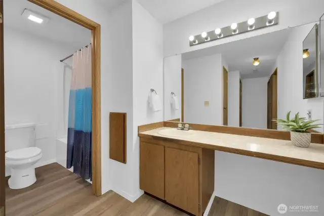 Private full ensuite featuring tub/shower combo and ample vanity storage.