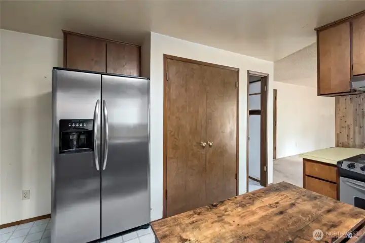 Stainless refrigerator and  door to pantry,