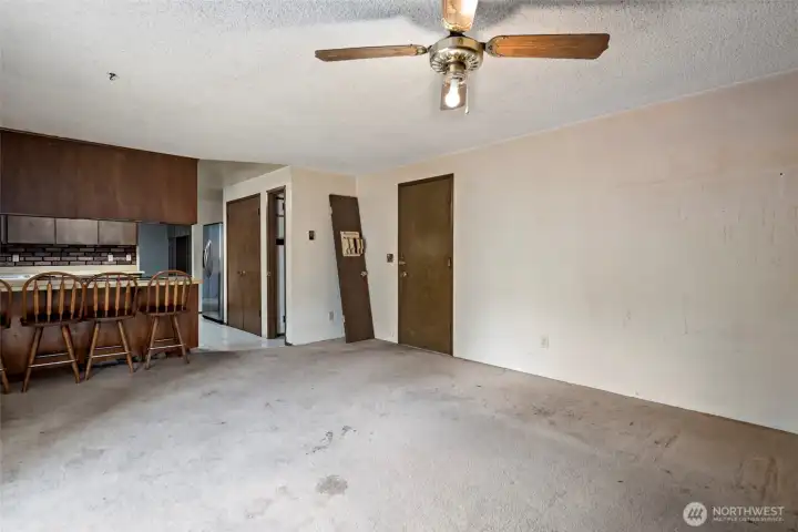 Family room looking towards kitchen to the left and door to the garage on the right.