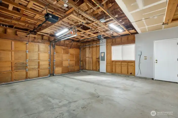 Large 2-car garage with tons of storage and built in ladder to access additional upper storage area