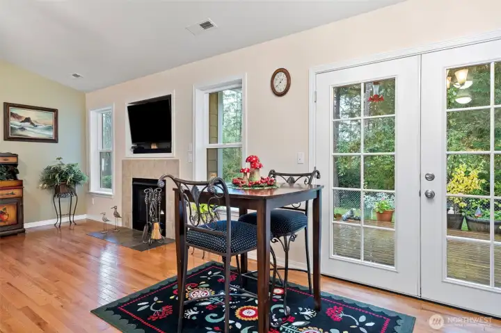 Dining Room with Oak Hardwood Floor and French Doors that Open to Private Deck