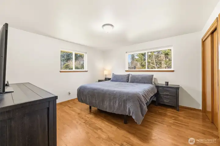 Spacious primary suite with hardwood floors.